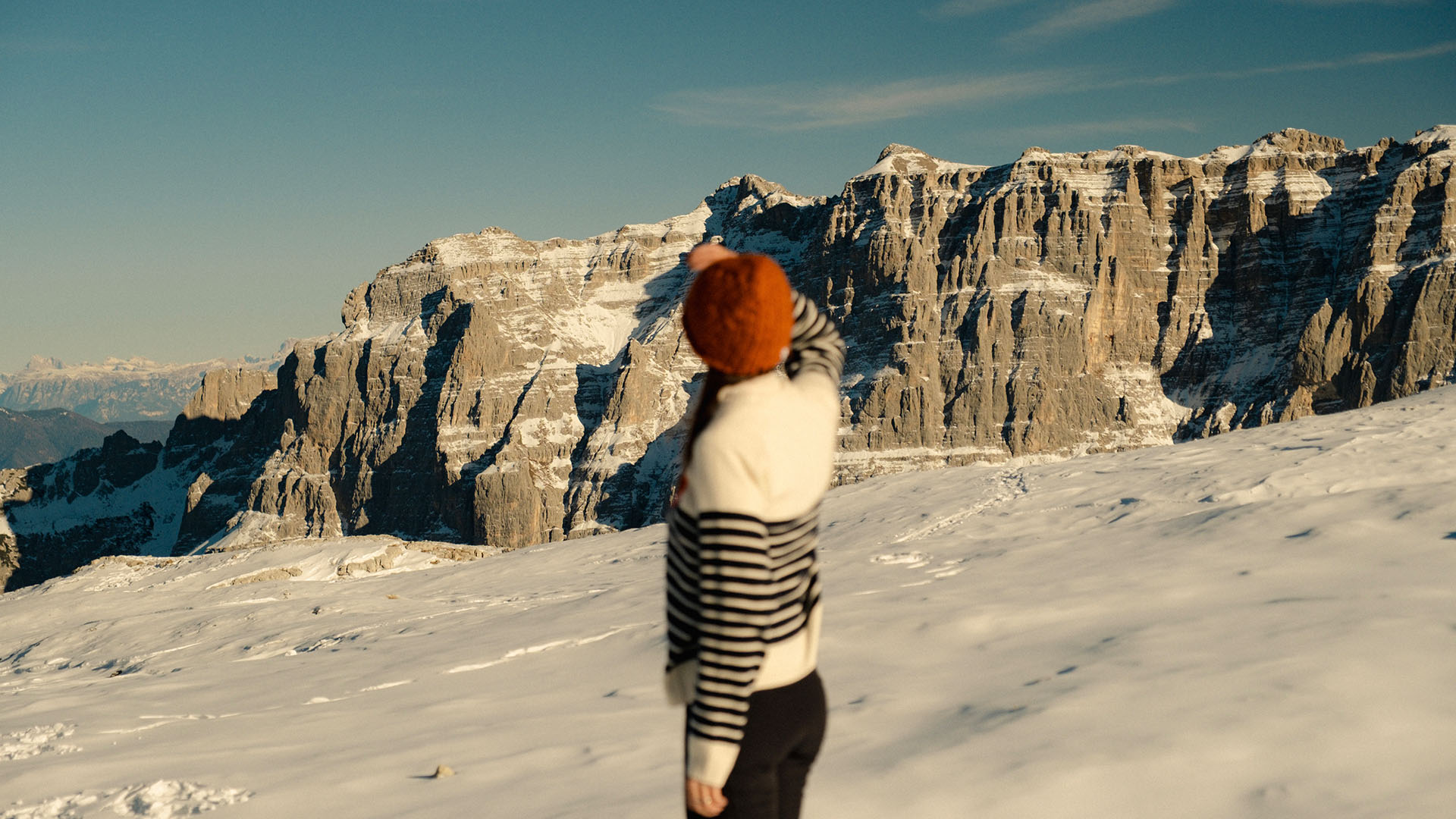 Person in snowy mountain landscape, representing travel and resort experience in nature